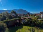 Blick in den Garten - Seltene Gelegenheit im Achental – DHH mit traumhaftem Bergblick und großem Potenzial